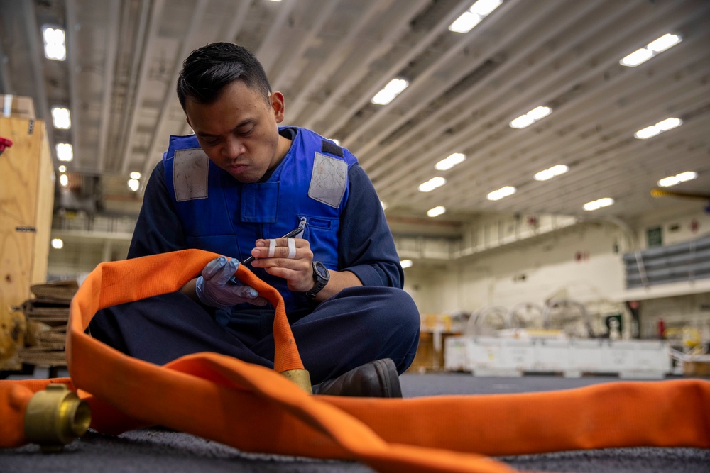 Sailors preform Maintinance onboard USS Tripoli