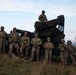 U.S. Soldiers pose in front of an Avenger Air Defense System