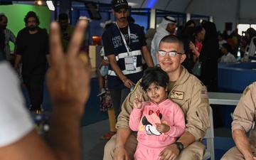 U.S. military personnel interact with spectators at the Bahrain International Airshow 2024