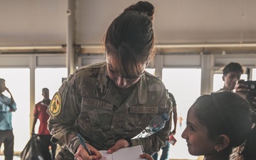 U.S. military personnel interact with spectators at the Bahrain International Airshow 2024