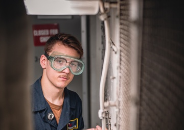 USS George Washington Sailors perform fan coil unit maintenance