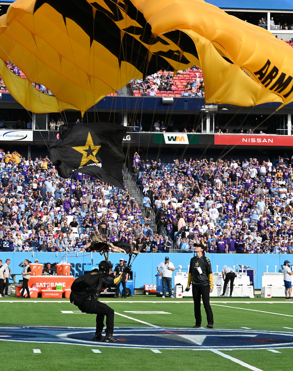 Members of the U.S. Army Parachute Team perform a demonstration jump into Nissan Stadium Sunday, November 17th, 2024.