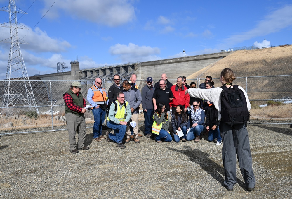 Public Affairs Specialist directs group photo during S.A.M.E tour