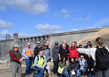 Public Affairs Specialist directs group photo during S.A.M.E tour