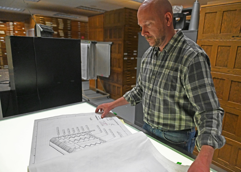 Ryan Laughery examines blueprints at the Walla Walla District building