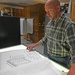 Ryan Laughery examines blueprints at the Walla Walla District building