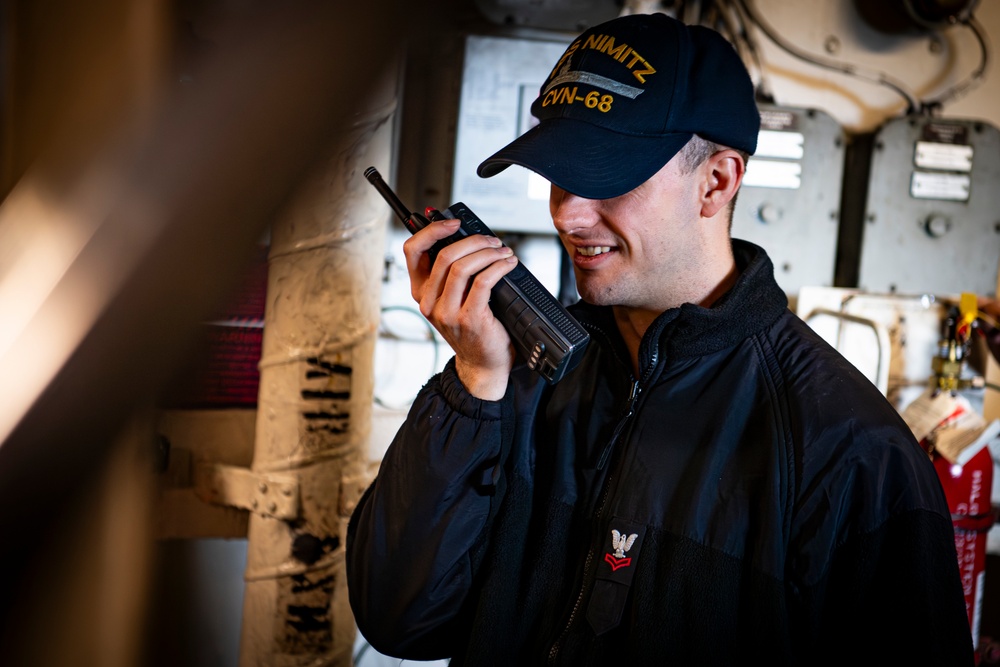 Nimitz Sailor Uses a Radio