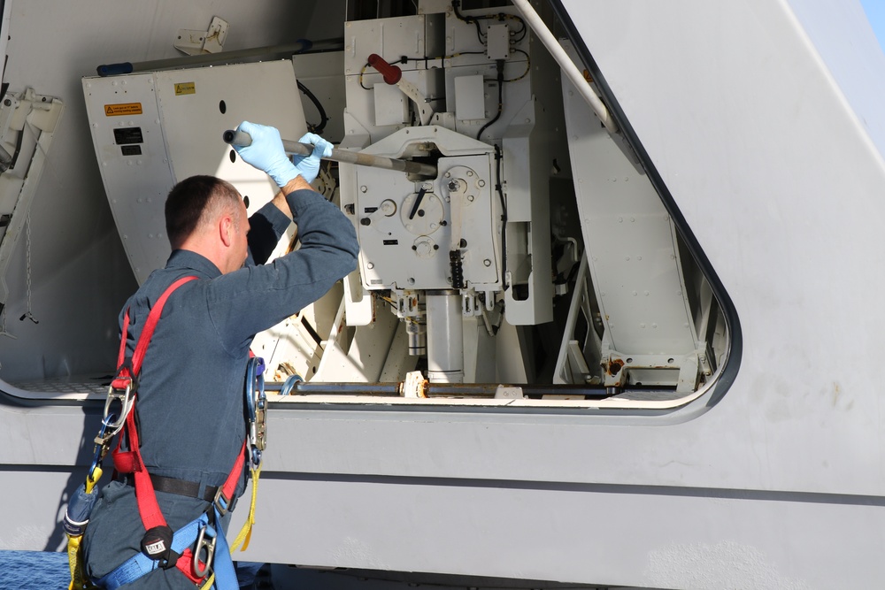 USS Tulsa (LCS 16) Sailor Conducts MK110 Maintenance