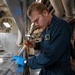 Nimitz Sailor Applies Caulking To Hot Plate Wells