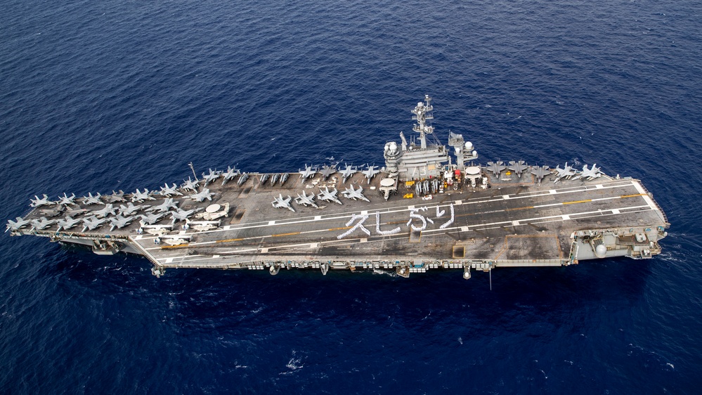 USS George Washington Sailors greet Japan with flight deck message