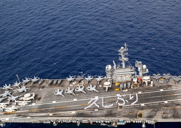 USS George Washington Sailors greet Japan with flight deck message