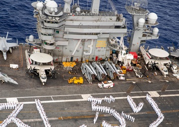 USS George Washington Sailors greet Japan with flight deck message