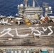 USS George Washington Sailors greet Japan with flight deck message