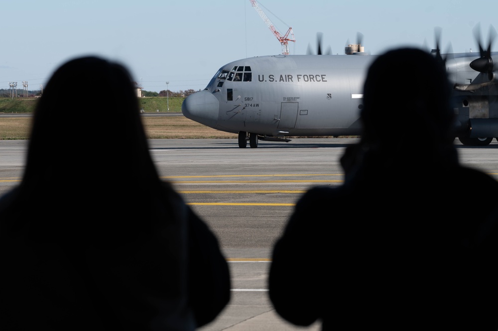 Spouses practice emergency evacuation through processing line, orientation flights