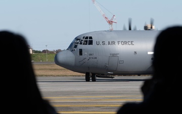 Spouses practice emergency evacuation through processing line, orientation flights