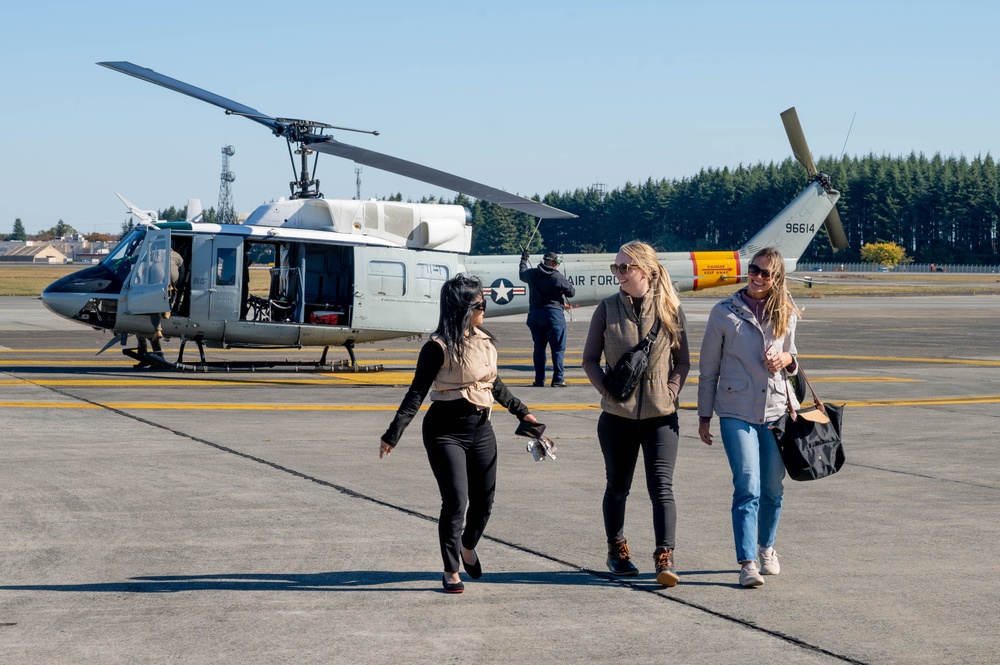 Spouses practice emergency evacuation through processing line, orientation flights