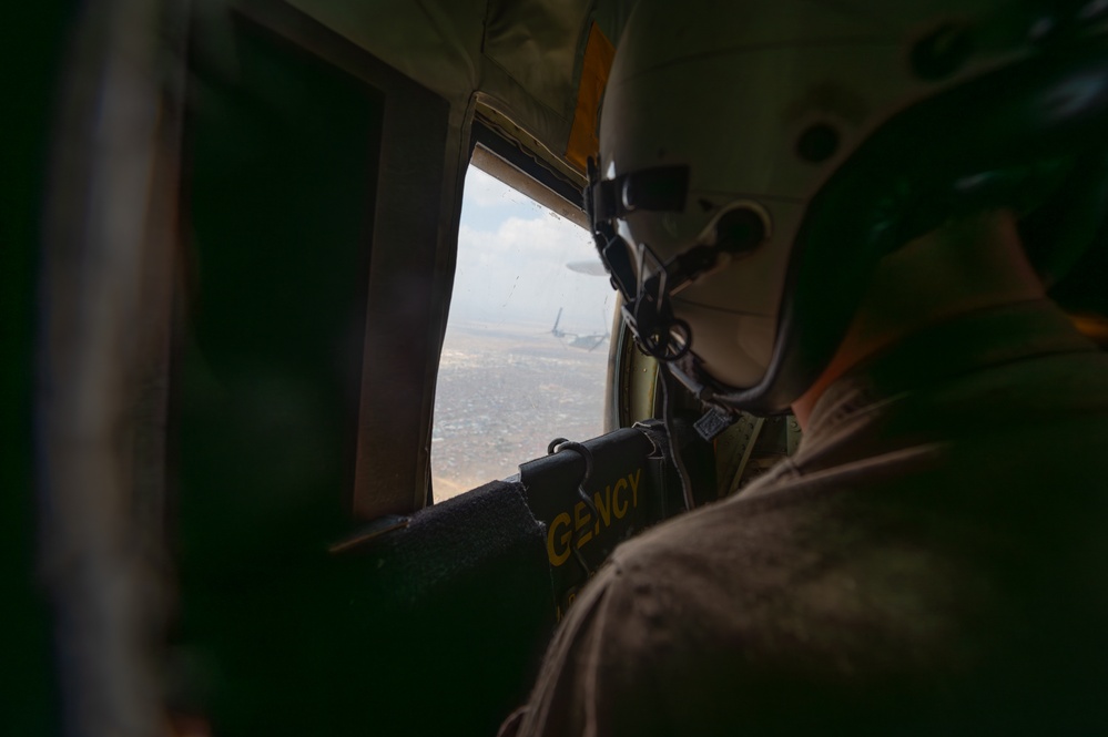 U.S. Marine Corps Loadmaster Watches VM-22 During Flyover