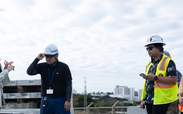 Members of the Defense Policy Review Initiative, U.S. Army Corps of Engineers, and the Okinawa Defense Bureau tour construction for new base housing