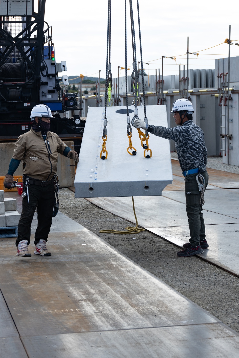 Members of the Defense Policy Review Initiative, U.S. Army Corps of Engineers, and the Okinawa Defense Bureau tour construction for new base housing