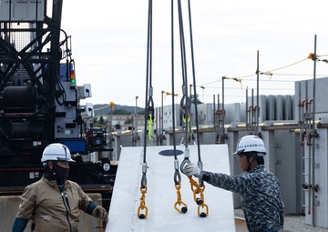 Members of the Defense Policy Review Initiative, U.S. Army Corps of Engineers, and the Okinawa Defense Bureau tour construction for new base housing