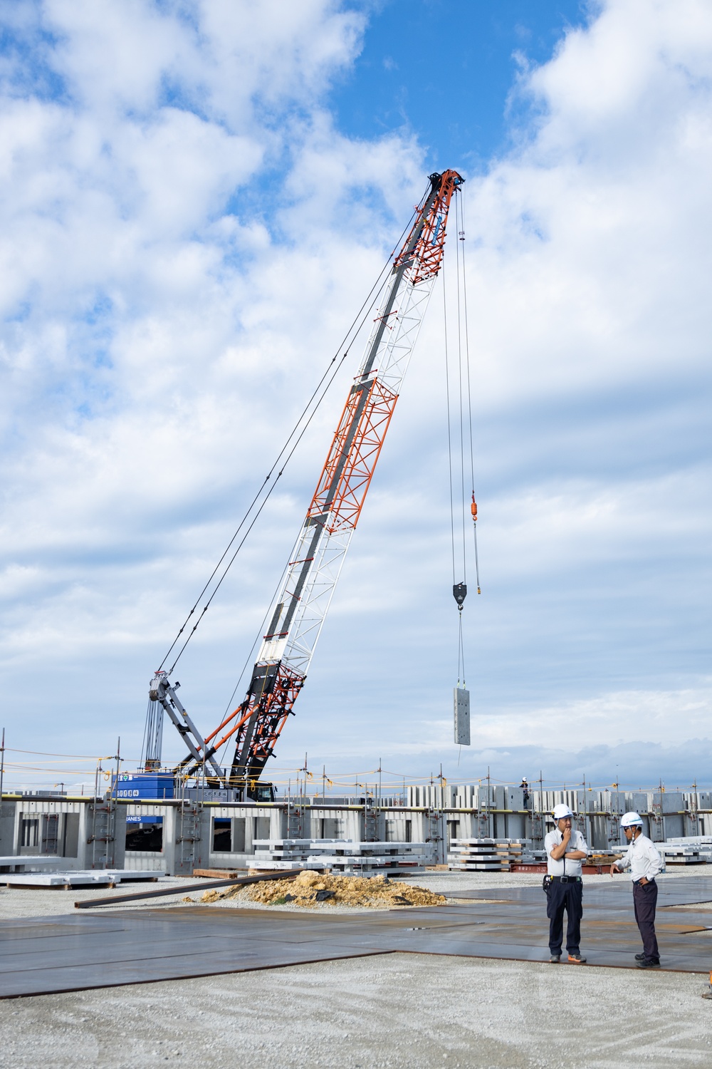 Members of the Defense Policy Review Initiative, U.S. Army Corps of Engineers, and the Okinawa Defense Bureau tour construction for new base housing