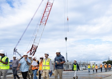 Members of the Defense Policy Review Initiative, U.S. Army Corps of Engineers, and the Okinawa Defense Bureau tour construction for new base housing