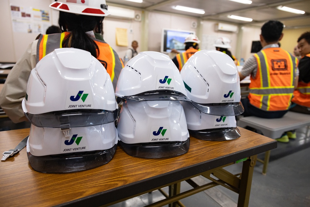 Members of the Defense Policy Review Initiative, U.S. Army Corps of Engineers, and the Okinawa Defense Bureau tour construction for new base housing