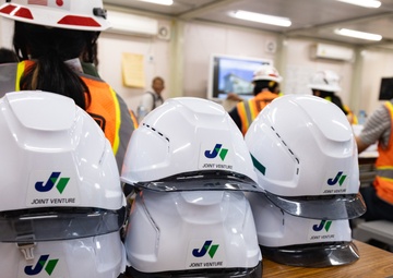 Members of the Defense Policy Review Initiative, U.S. Army Corps of Engineers, and the Okinawa Defense Bureau tour construction for new base housing