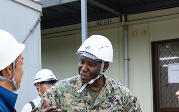 Members of the Defense Policy Review Initiative, U.S. Army Corps of Engineers, and the Okinawa Defense Bureau tour construction for new base housing