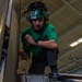 Sailor conducts aircraft maintenance in the hangar bay of USS Carl Vinson (CVN 70)