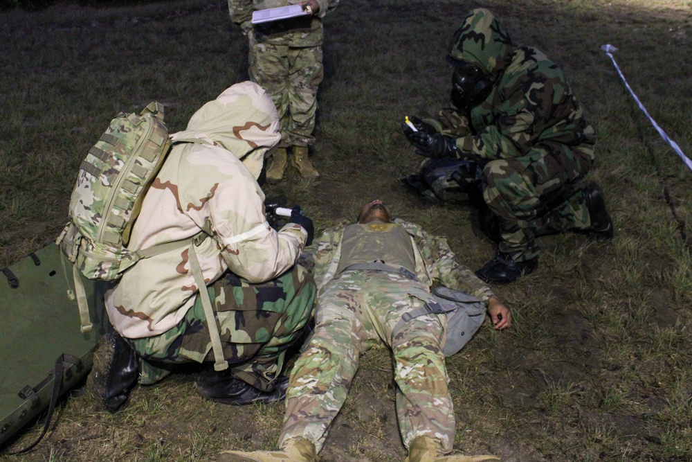 Soldiers Evaluate a Simulated CBRN Casualty at Medical Readiness Command, West, Best Medic Competition 2024