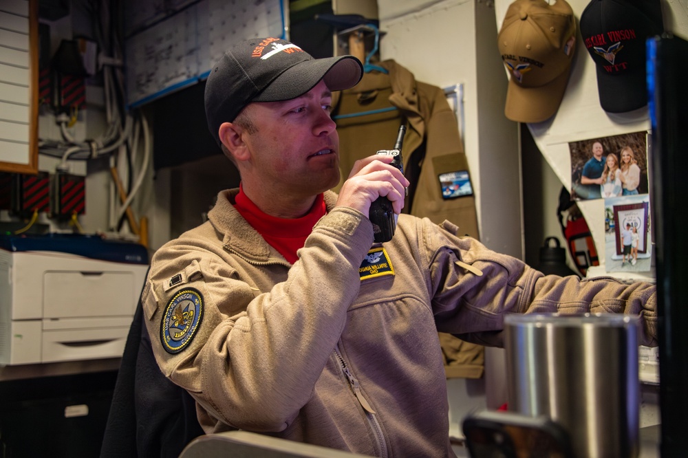 A USS Carl Vinson (CVN 70) Officer Coordinates an Ordnance Evolution
