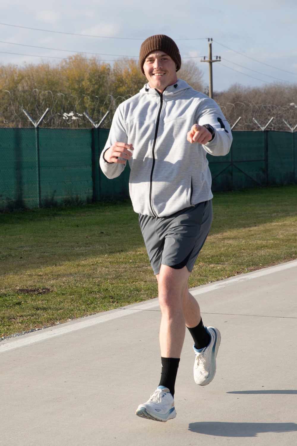 U.S. Soldier points at the camera as they run