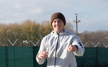 U.S. Soldier points at the camera as they run