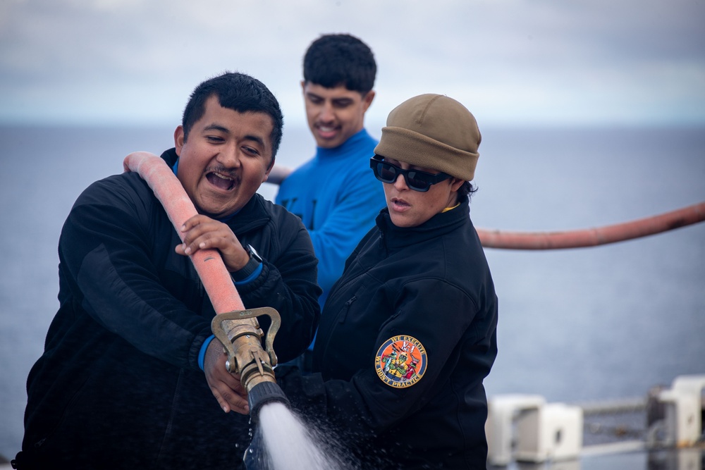 USS Tripoli Sailors wash the flight deck