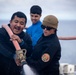 USS Tripoli Sailors wash the flight deck