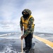 USS Tripoli Sailors wash the flight deck