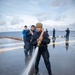 USS Tripoli Sailors wash the flight deck