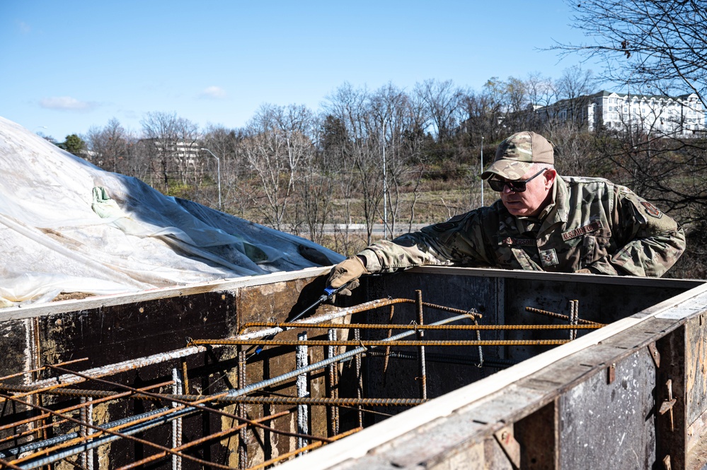 911th CES pours concrete for upcoming legacy monument