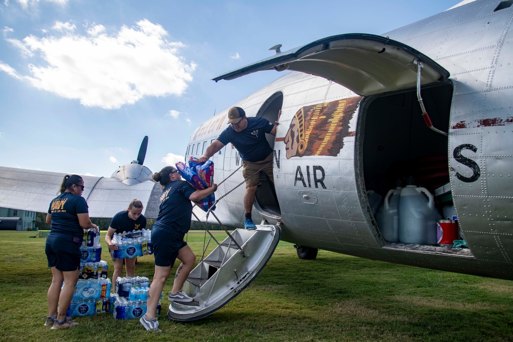 NAS Oceana Sailors help load hurricane relief supplies onto historic DC-3 with Military Aviation Museum