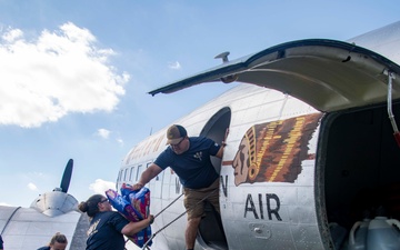 NAS Oceana Sailors help load hurricane relief supplies onto historic DC-3 with Military Aviation Museum