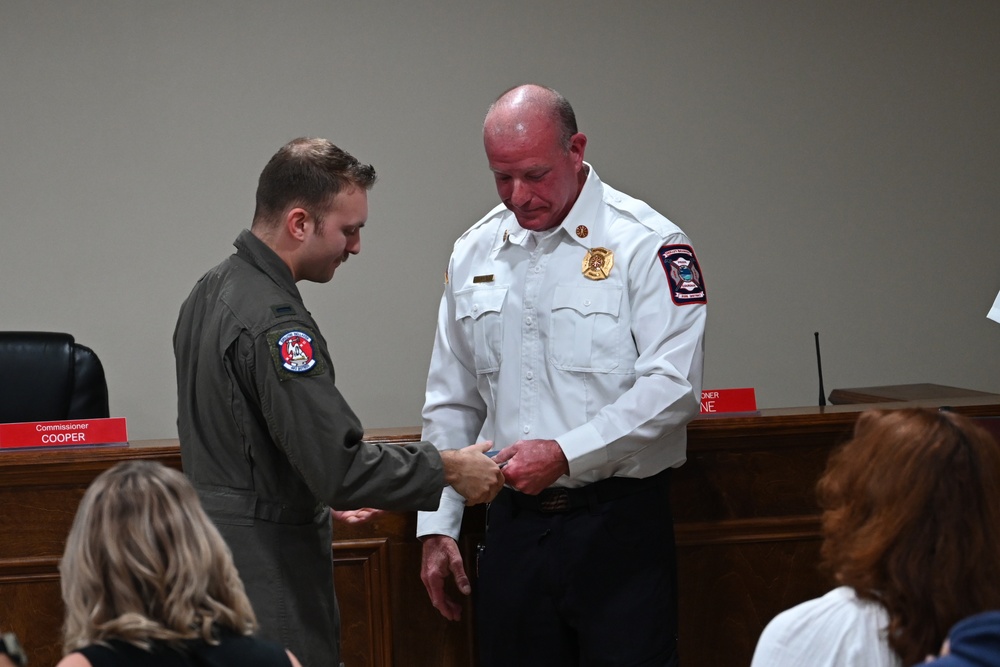 Airmen, civilians unite to save mother, son from submerged vehicle