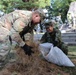 765th Transportation (Terminal) Bn. Soldiers, Japan Ground Self-Defense Force members work together to beautify historical stone monument on Camp Zama