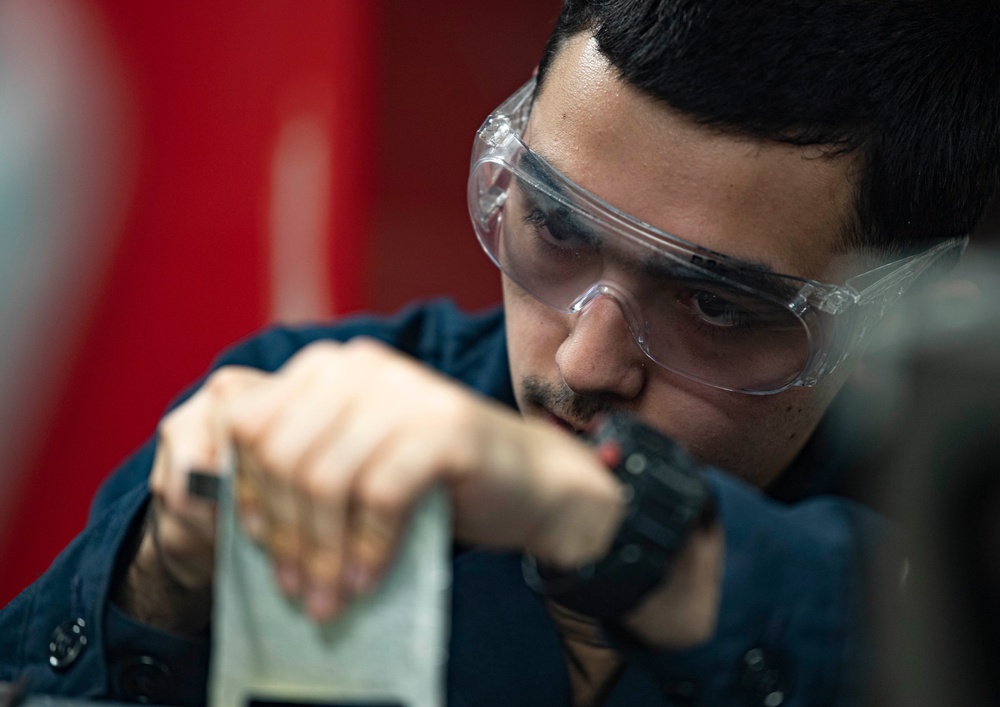 Aviation Structural Mechanic Files Launch Bar Placards in the Jet Shop Aboard USS Carl Vinson (CVN 70)