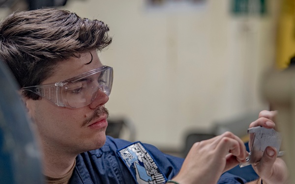 Aviation Structural Mechanic Files Launch Bar Placards in the Jet Shop Aboard USS Carl Vinson (CVN 70)