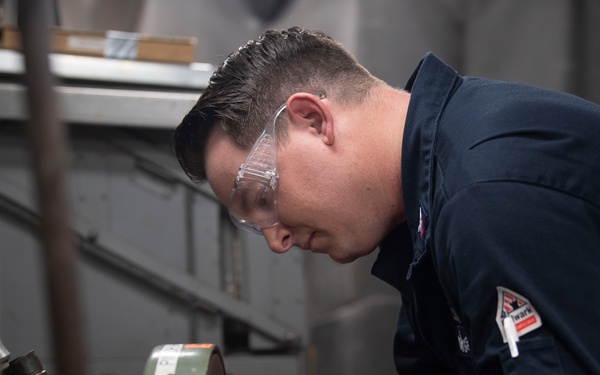 Aviation Structural Mechanic Fabricates a Patch in the Jet Shop Aboard USS Carl Vinson (CVN 70)