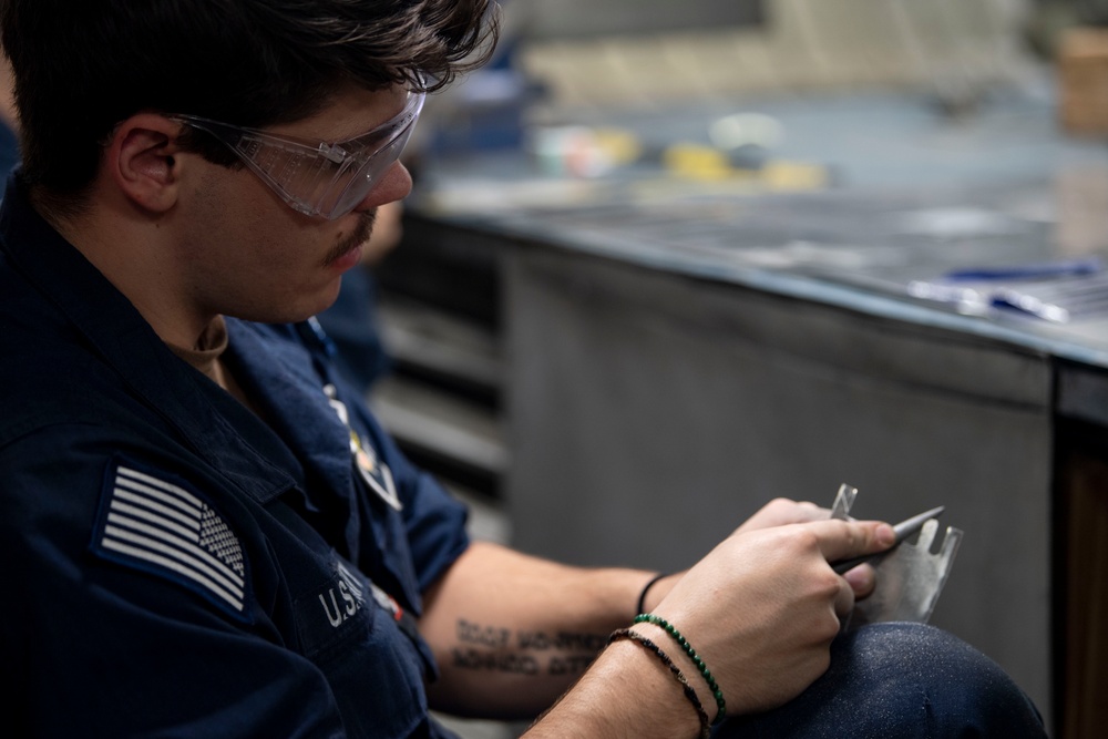 Aviation Structural Mechanic Files Launch Bar Placards in the Jet Shop Aboard USS Carl Vinson (CVN 70)