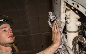 Aviation Machinist’s Mate Performs Preventative Maintenance on an E-2D Advance Hawkeye