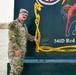 Soldier paints concrete barrier.