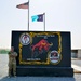 Soldier paints concrete barrier.